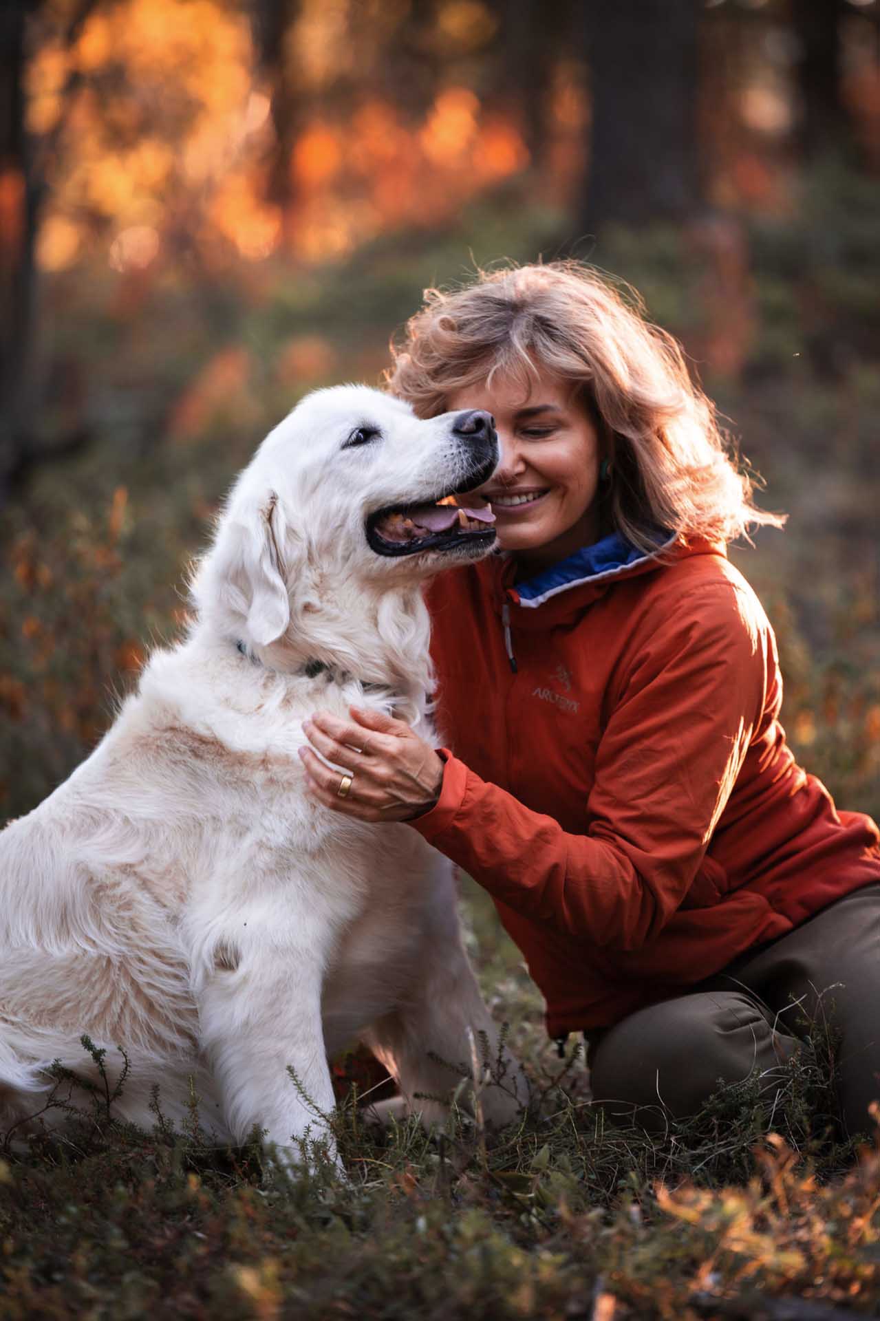 woman hugging a fluffy dog